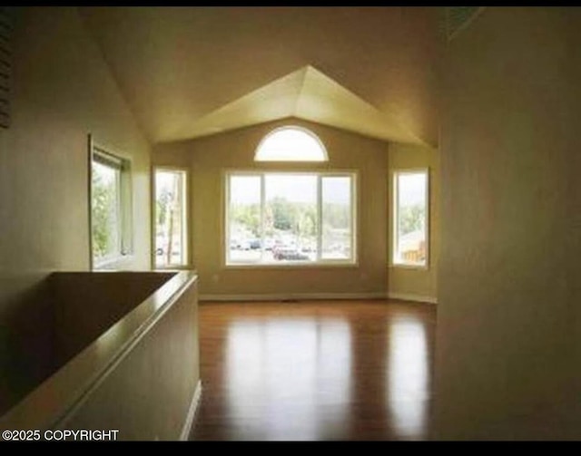 7252 Glade Pl # 4, Anchorage, AK 99518 - unfurnished room featuring lofted ceiling and wood finished floors
