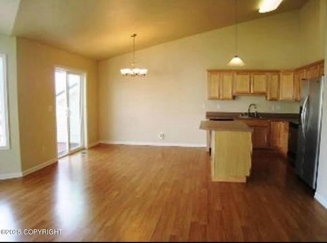 7252 Glade Pl # 4, Anchorage, AK 99518 - kitchen featuring lofted ceiling, freestanding refrigerator, open floor plan, dark wood-type flooring, and a chandelier