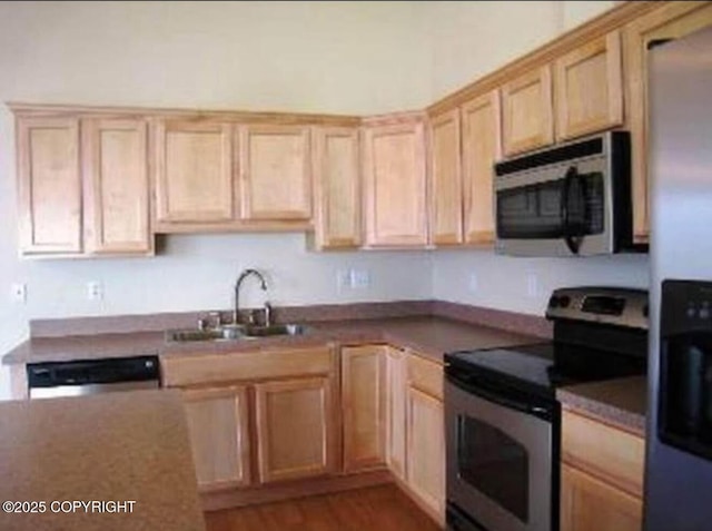 7252 Glade Pl # 4, Anchorage, AK 99518 - kitchen featuring appliances with stainless steel finishes, light brown cabinetry, and wood finished floors
