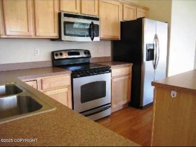 7252 Glade Pl # 4, Anchorage, AK 99518 - kitchen with appliances with stainless steel finishes, light wood-style flooring, and light brown cabinets