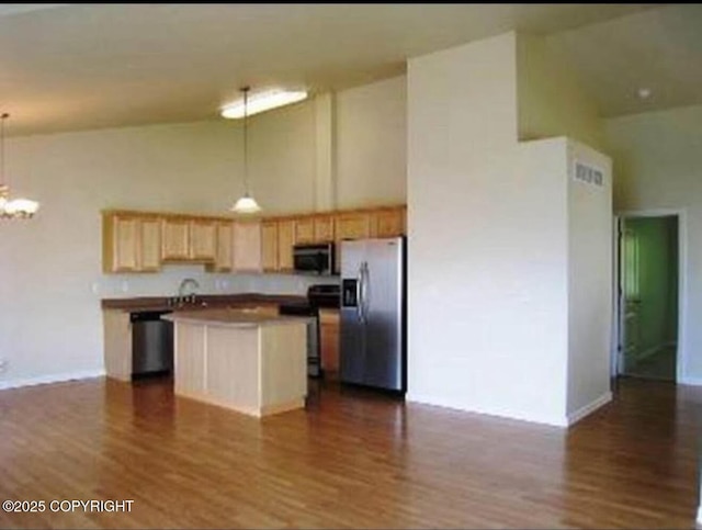7252 Glade Pl # 4, Anchorage, AK 99518 - kitchen featuring stainless steel appliances, high vaulted ceiling, light brown cabinetry, and dark wood-type flooring