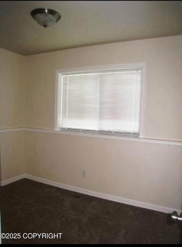 7252 Glade Pl # 4, Anchorage, AK 99518 - spare room with baseboards and dark carpet