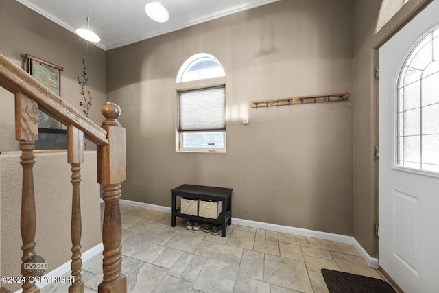 4745 Manytell Ave, Anchorage, AK 99516 - entryway with plenty of natural light, crown molding, baseboards, stairs, and stone tile flooring