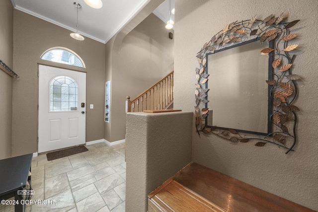 4745 Manytell Ave, Anchorage, AK 99516 - entrance foyer featuring ornamental molding, stone tile floors, arched walkways, stairs, and a textured wall