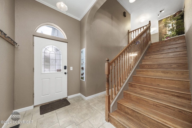 4745 Manytell Ave, Anchorage, AK 99516 - entryway with healthy amount of natural light, stairway, baseboards, crown molding, and a towering ceiling