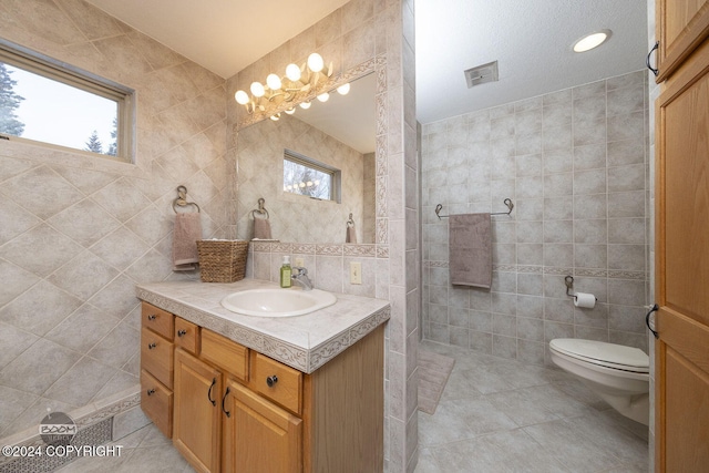4745 Manytell Ave, Anchorage, AK 99516 - bathroom with tile walls, tile patterned floors, vanity, toilet, and walk in shower