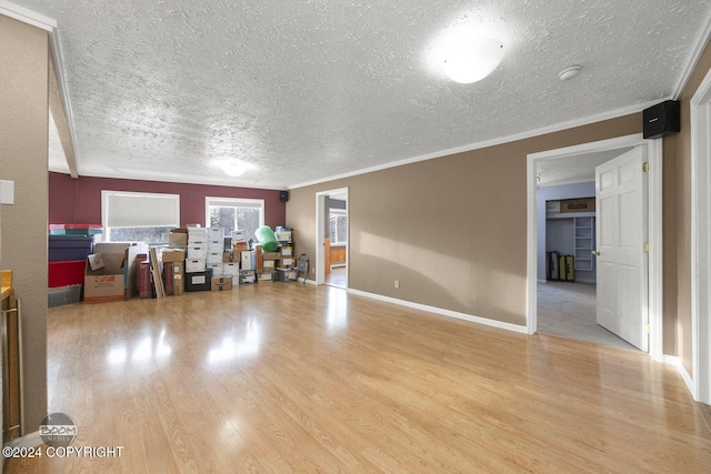 4745 Manytell Ave, Anchorage, AK 99516 - living area with a textured ceiling, light wood finished floors, ornamental molding, and baseboards