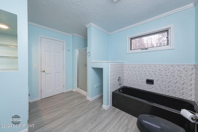 4745 Manytell Ave, Anchorage, AK 99516 - bathroom with a garden tub, wood finished floors, ornamental molding, toilet, and a stall shower
