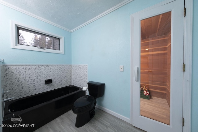 4745 Manytell Ave, Anchorage, AK 99516 - bathroom with a garden tub, ornamental molding, wood finished floors, toilet, and a textured ceiling