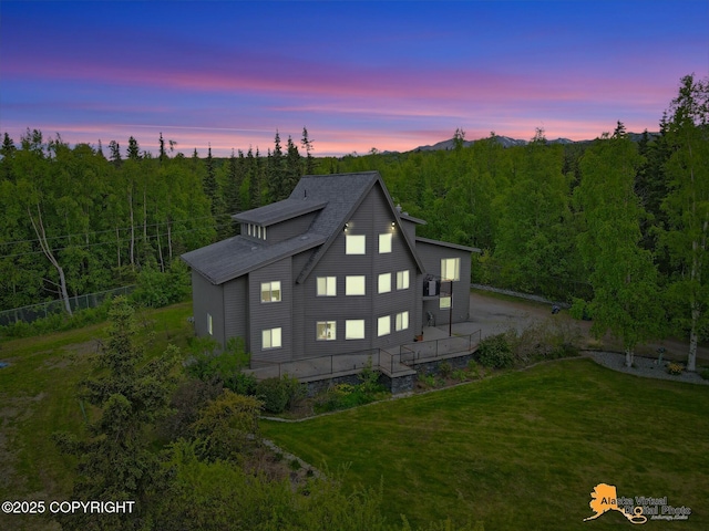 4745 Manytell Ave, Anchorage, AK 99516 - back of property at dusk featuring a view of trees and a yard