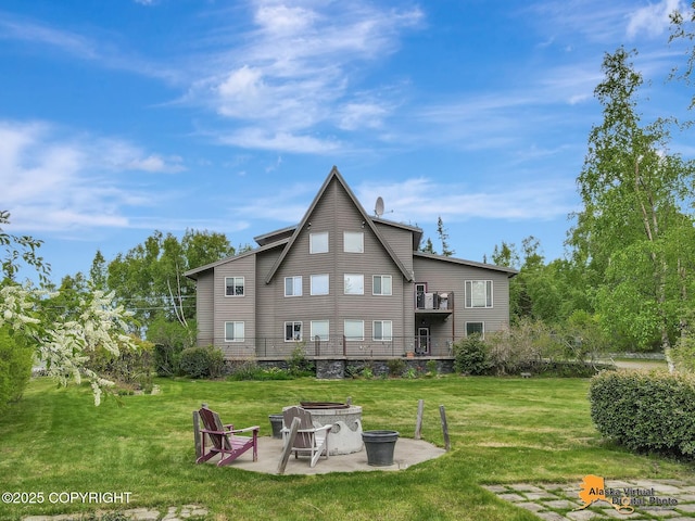 4745 Manytell Ave, Anchorage, AK 99516 - back of house with a fire pit, a yard, a patio, and a balcony
