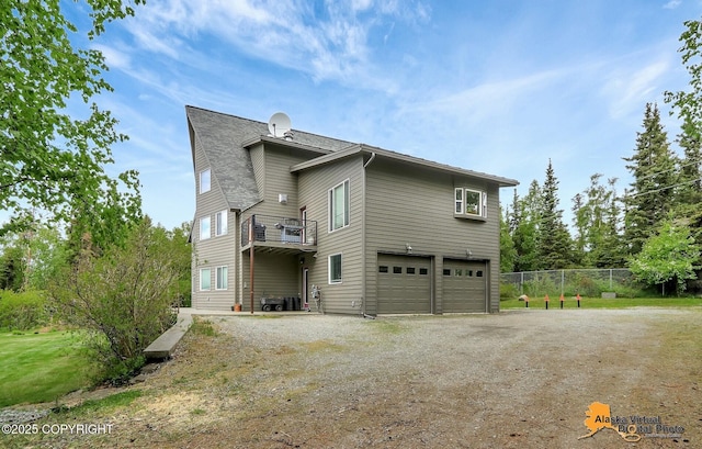 4745 Manytell Ave, Anchorage, AK 99516 - rear view of house featuring driveway, an attached garage, and a shingled roof