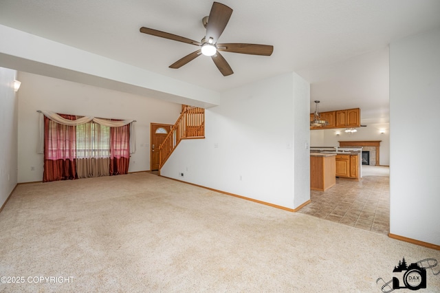 118 S Vickie Cir, Palmer, AK 99645 - unfurnished living room with light carpet, stairway, a ceiling fan, and baseboards