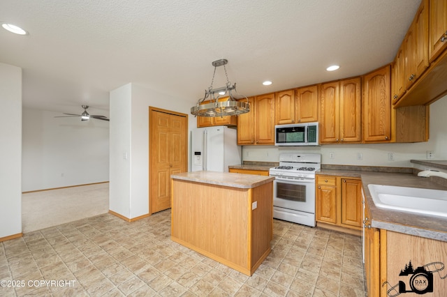 118 S Vickie Cir, Palmer, AK 99645 - kitchen featuring white appliances, a sink, recessed lighting, a center island, and ceiling fan