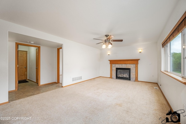 118 S Vickie Cir, Palmer, AK 99645 - unfurnished living room with carpet flooring, ceiling fan, a tile fireplace, and baseboards