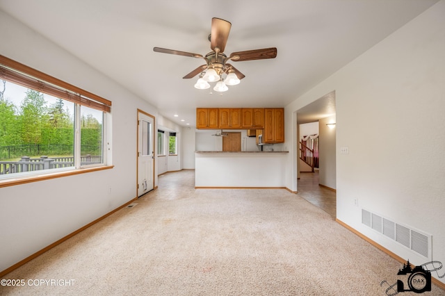 118 S Vickie Cir, Palmer, AK 99645 - unfurnished living room featuring light carpet, baseboards, and ceiling fan