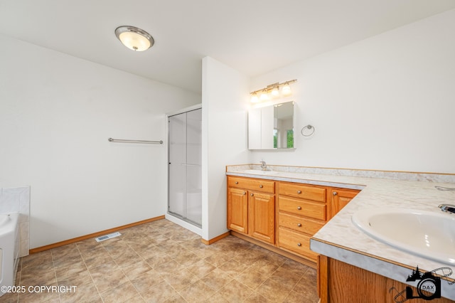 118 S Vickie Cir, Palmer, AK 99645 - bathroom with double vanity, a stall shower, a bath, and baseboards