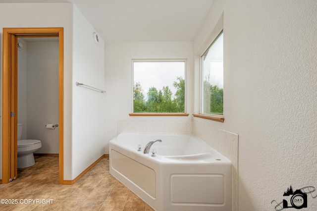 118 S Vickie Cir, Palmer, AK 99645 - bathroom with a garden tub, toilet, tile patterned floors, and baseboards
