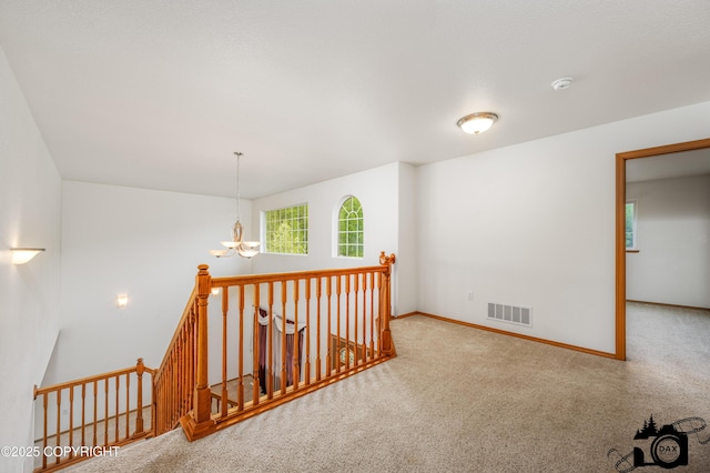 118 S Vickie Cir, Palmer, AK 99645 - corridor with a chandelier, an upstairs landing, carpet, and baseboards