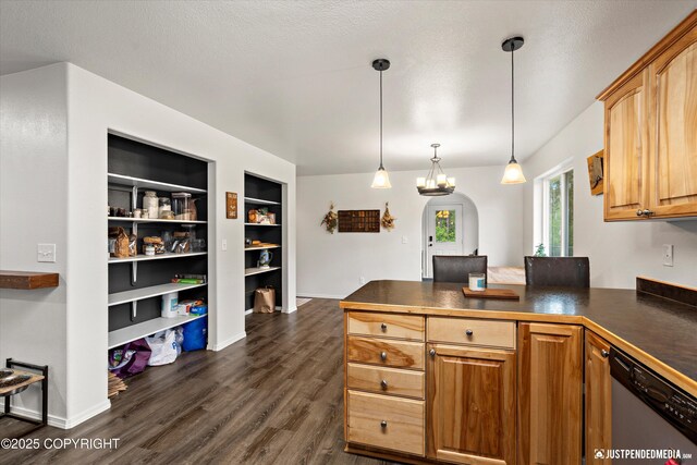 7490 W Rodney Cir, Wasilla, AK 99623 - kitchen with dishwasher, dark countertops, a peninsula, dark wood-style flooring, and arched walkways