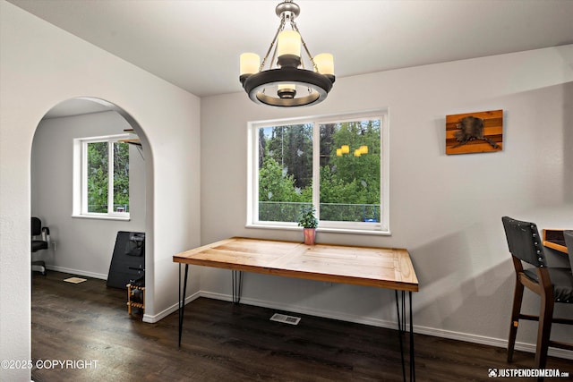 7490 W Rodney Cir, Wasilla, AK 99623 - dining room featuring arched walkways, dark wood-type flooring, and plenty of natural light