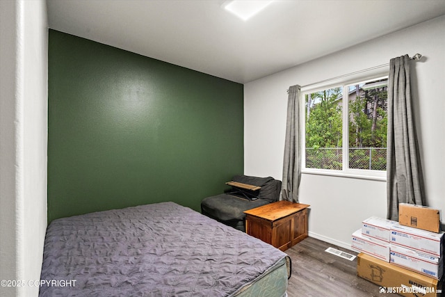 7490 W Rodney Cir, Wasilla, AK 99623 - bedroom featuring wood finished floors and baseboards