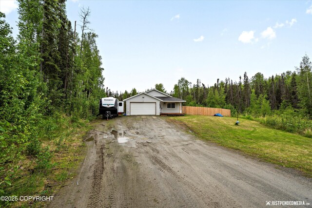7490 W Rodney Cir, Wasilla, AK 99623 - single story home with dirt driveway and a garage