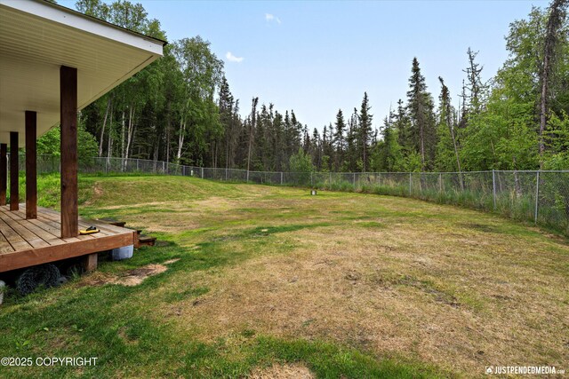 7490 W Rodney Cir, Wasilla, AK 99623 - view of yard featuring a deck and a forest view
