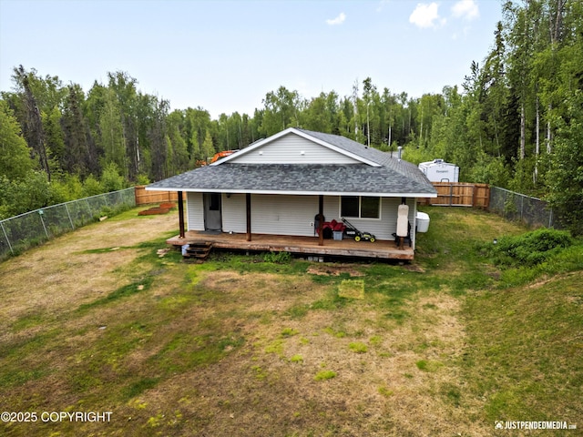 7490 W Rodney Cir, Wasilla, AK 99623 - back of property with a wooden deck, a shingled roof, and a forest view