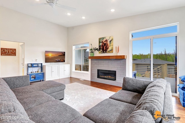 5466 Sandhill Loop, Anchorage, AK 99502 - living room with wood finished floors, ceiling fan, a brick fireplace, and recessed lighting