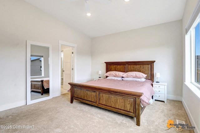 5466 Sandhill Loop, Anchorage, AK 99502 - bedroom with light carpet, multiple windows, baseboards, and ensuite bathroom