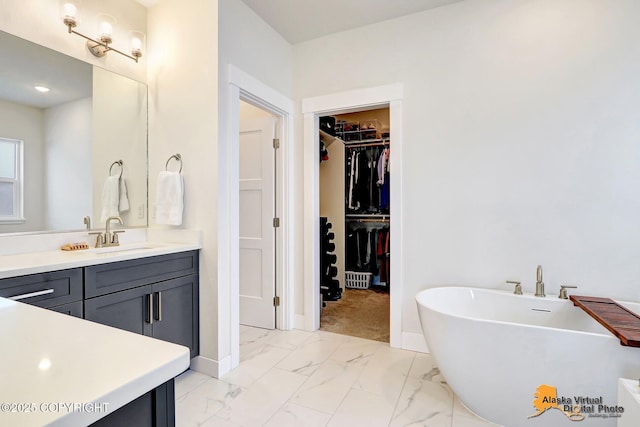 5466 Sandhill Loop, Anchorage, AK 99502 - full bath with a freestanding tub, a spacious closet, baseboards, and vanity