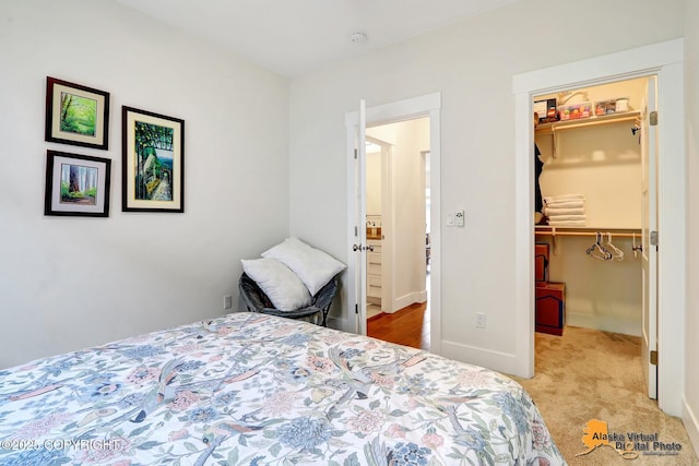 5466 Sandhill Loop, Anchorage, AK 99502 - bedroom with a spacious closet, carpet floors, and a closet