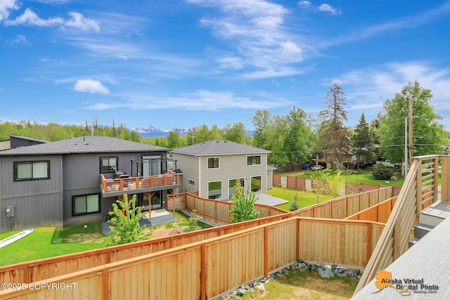 5466 Sandhill Loop, Anchorage, AK 99502 - rear view of property featuring a wooden deck and a fenced backyard