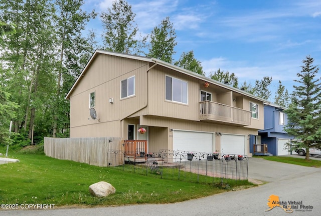 2598 Brookshire Loop # 27, Anchorage, AK 99504 - townhome / multi-family property with an attached garage, a balcony, and driveway