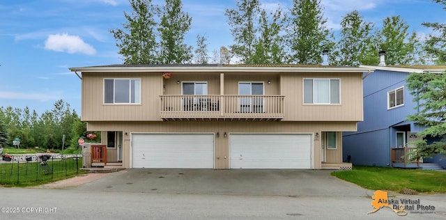 2598 Brookshire Loop # 27, Anchorage, AK 99504 - view of front of home with a balcony, a garage, and driveway