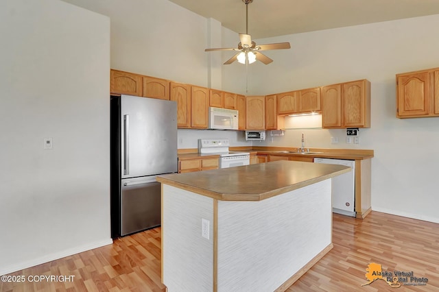 2598 Brookshire Loop # 27, Anchorage, AK 99504 - kitchen with white appliances, high vaulted ceiling, ceiling fan, light wood-type flooring, and a kitchen island