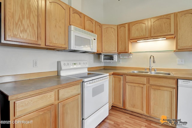 2598 Brookshire Loop # 27, Anchorage, AK 99504 - kitchen featuring white appliances, light brown cabinets, and light wood finished floors