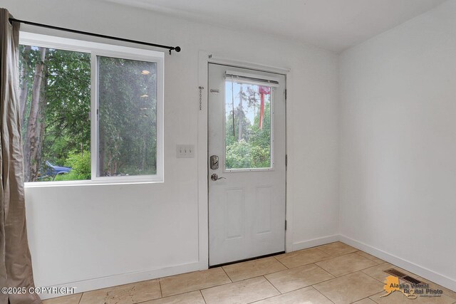 8825 W Mcquire Ln, Wasilla, AK 99623 - doorway featuring light tile patterned flooring and baseboards
