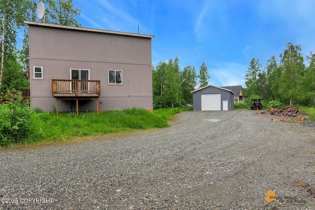 8825 W Mcquire Ln, Wasilla, AK 99623 - view of home's exterior with a garage, an outdoor structure, and driveway