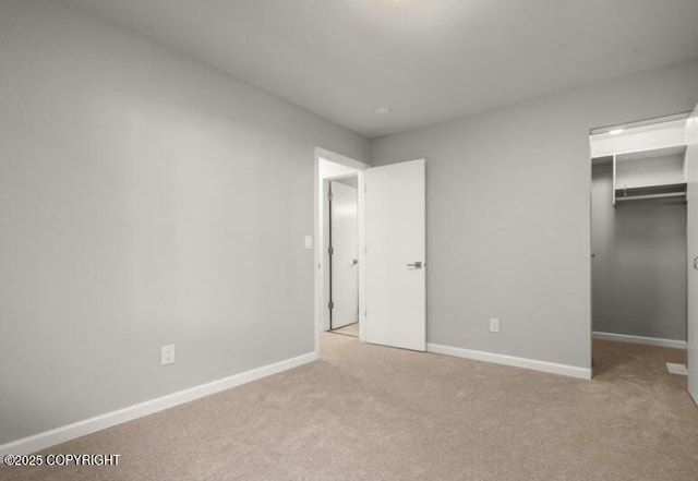 2551 La Honda Dr, Anchorage, AK 99517 - unfurnished bedroom with carpet floors, baseboards, and a walk in closet