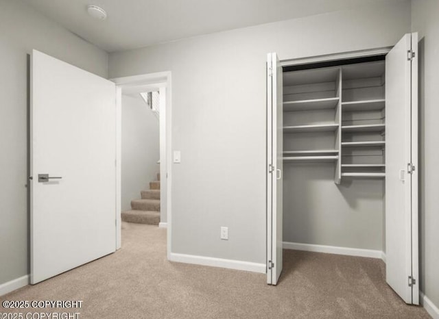 2551 La Honda Dr, Anchorage, AK 99517 - unfurnished bedroom with carpet flooring, a closet, and baseboards