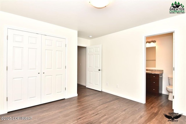 310 Park Way N, Pole, AK 99705 - unfurnished bedroom featuring dark wood-type flooring, a closet, connected bathroom, and baseboards