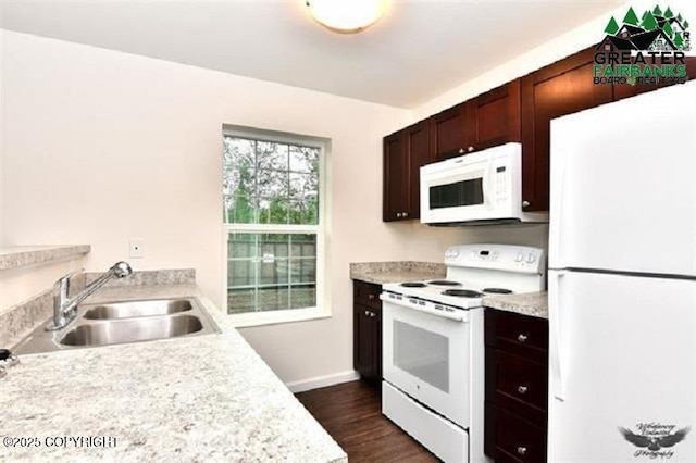 310 Park Way N, Pole, AK 99705 - kitchen with white appliances, a sink, light countertops, dark wood-type flooring, and baseboards