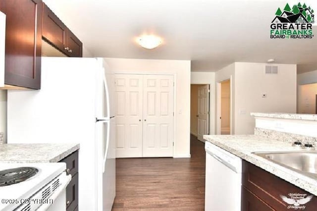 310 Park Way N, Pole, AK 99705 - kitchen with dishwasher, dark wood-type flooring, dark brown cabinetry, a sink, and light stone countertops