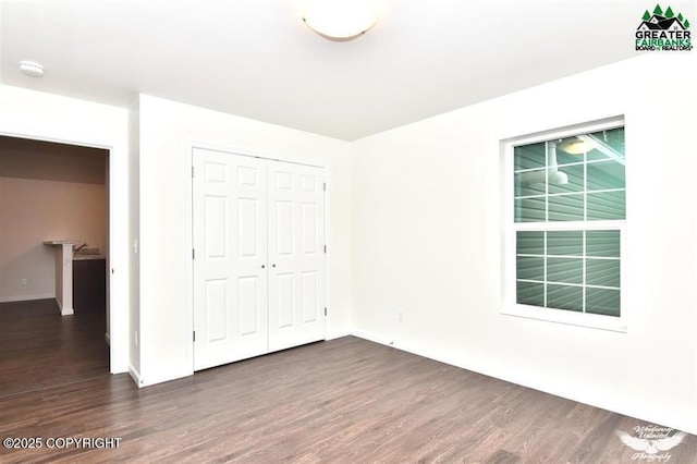 310 Park Way N, Pole, AK 99705 - unfurnished bedroom with wood finished floors, a closet, and baseboards