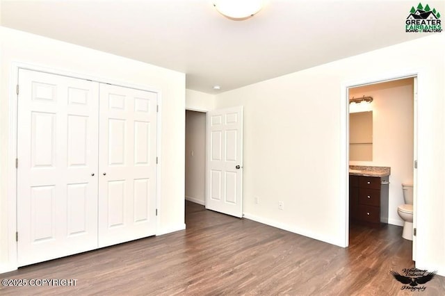 310 Park Way N, Pole, AK 99705 - unfurnished bedroom with dark wood finished floors, a closet, ensuite bath, and baseboards