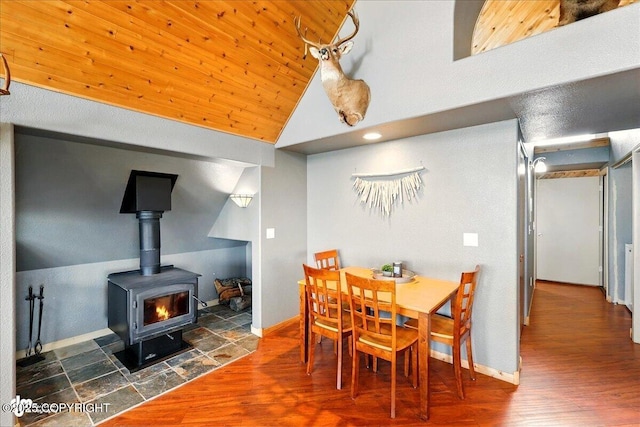 11091 Crestline Ln, Clam Gulch, AK 99568 - dining area featuring high vaulted ceiling, wood finished floors, a wood stove, and baseboards