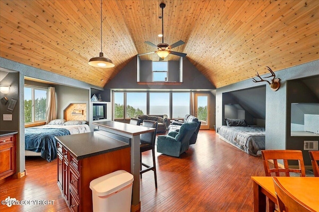 11091 Crestline Ln, Clam Gulch, AK 99568 - kitchen with open floor plan, dark countertops, high vaulted ceiling, a ceiling fan, and a breakfast bar area