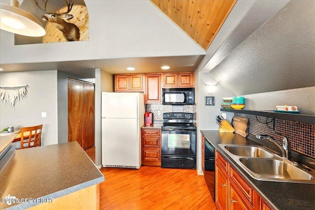 11091 Crestline Ln, Clam Gulch, AK 99568 - kitchen with black appliances, a sink, light wood-type flooring, tasteful backsplash, and lofted ceiling
